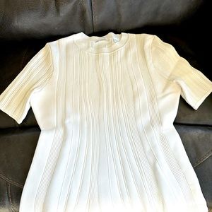 White, fitted blouse with flare at waist